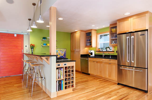 A kitchen with built-in storage space at the end of the island