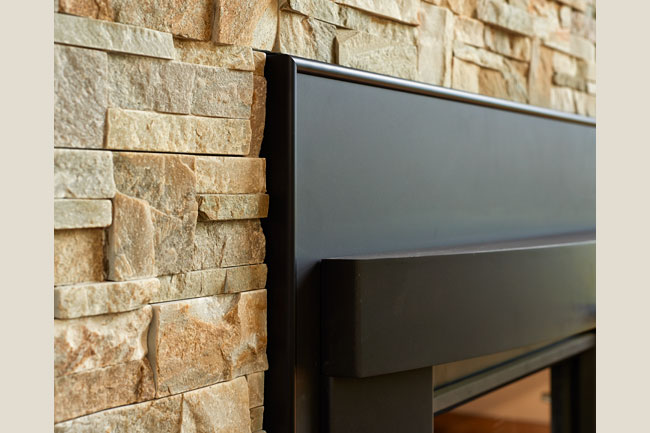 Stone detail around a fireplace in a remodel project by W.L. Construction in Corvallis, Oregon.