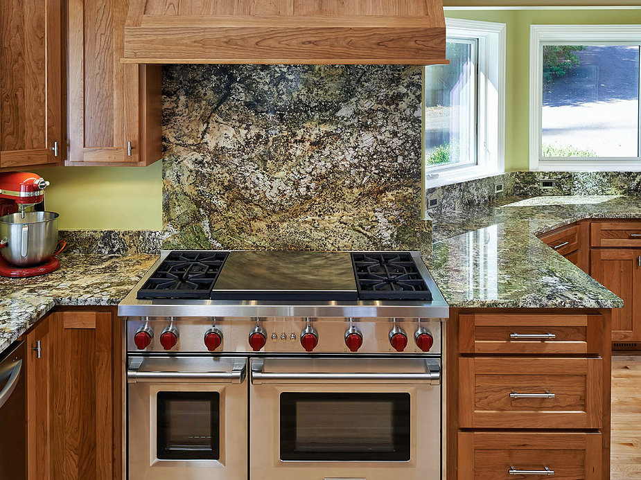 Kitchen with oversized cooktop and oven, marble countertops and backsplash, remodeled by W.L. Construction in Corvallis, Oregon.