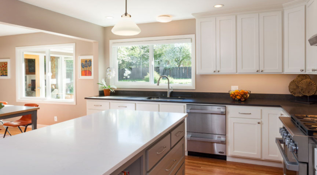 Bright, white kitchen remodel with new windows and custom cabinets by W.L. Construction in Corvallis, Oregon.