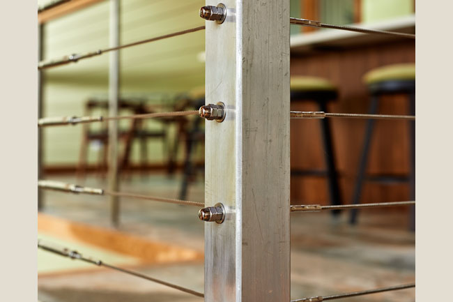 Stainless steel railings are modern and light in this remodel project by W.L. Construction in Corvallis, Oregon.