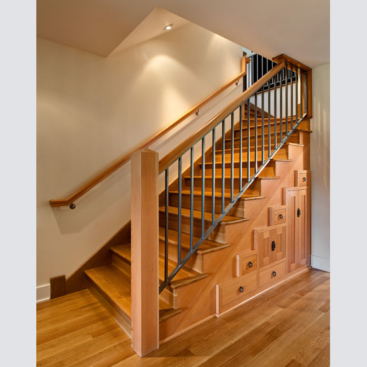 Cabinetry below the staircase is both beautiful and functional.