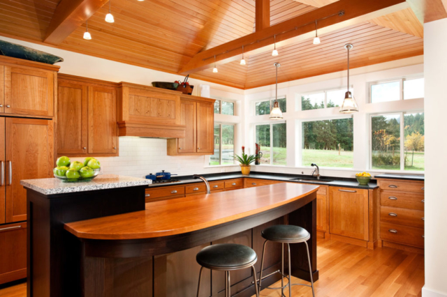 An open floor plan, including in the kitchen, provides plenty of light and space. Note the details in the trim and cabinets.